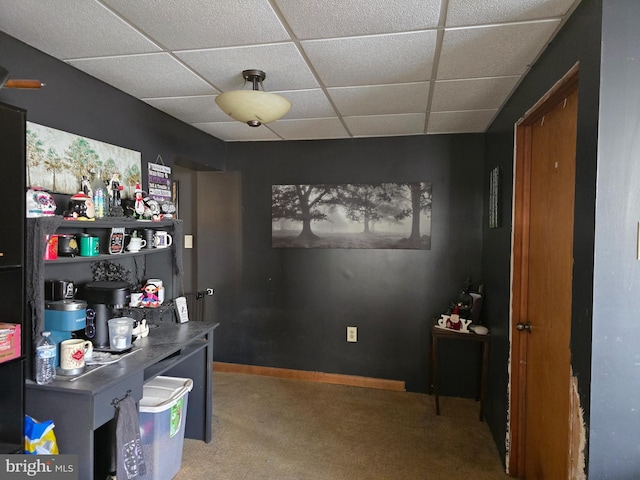 carpeted home office featuring a drop ceiling