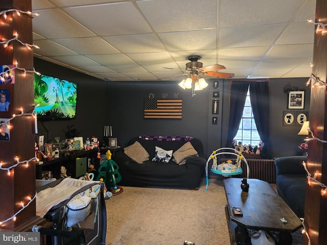 game room with a paneled ceiling, ceiling fan, and carpet floors