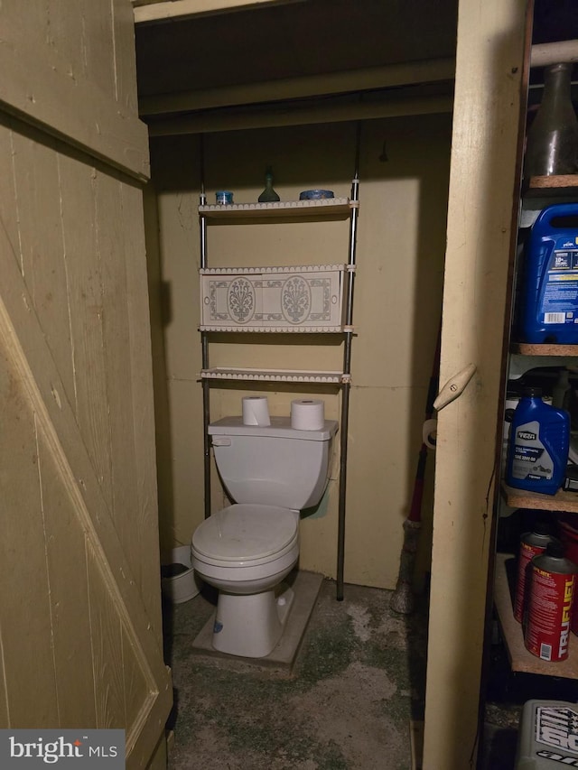 bathroom featuring concrete floors and toilet