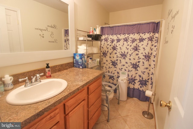 bathroom with tile patterned floors, toilet, vanity, and a shower with shower curtain