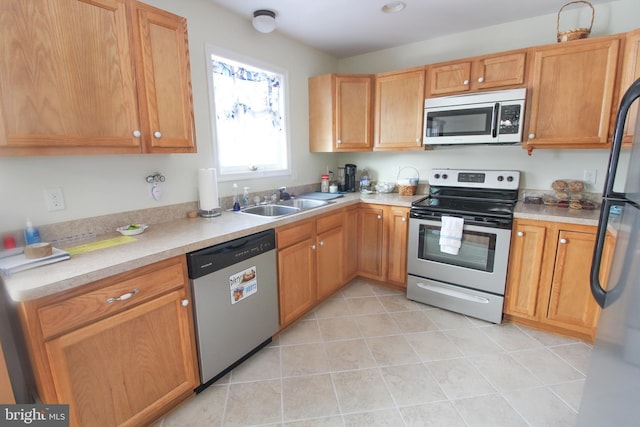 kitchen with light tile patterned floors, sink, and appliances with stainless steel finishes