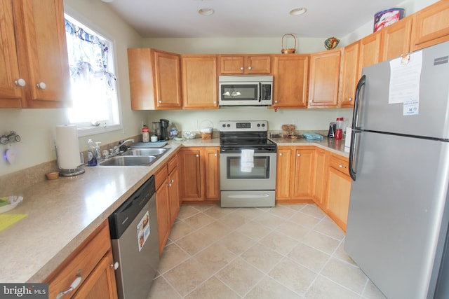 kitchen featuring light tile patterned floors, sink, and appliances with stainless steel finishes