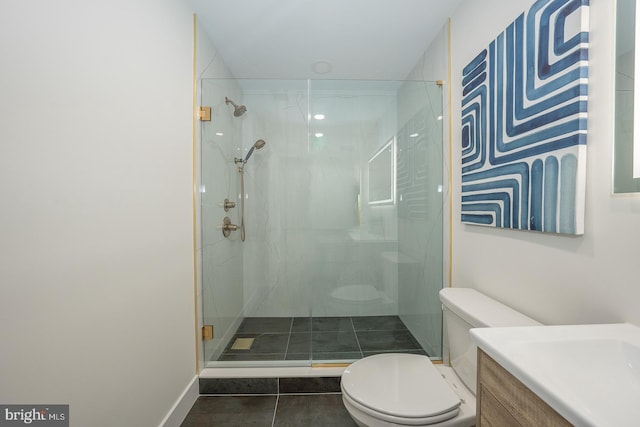 bathroom featuring tile patterned floors, a shower with door, vanity, and toilet