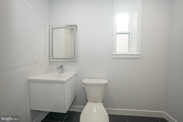 bathroom with tile patterned flooring, vanity, and toilet