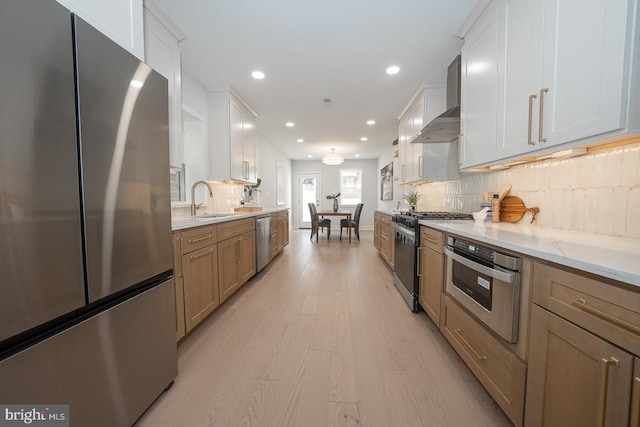 kitchen with white cabinets, stainless steel appliances, tasteful backsplash, and light stone countertops