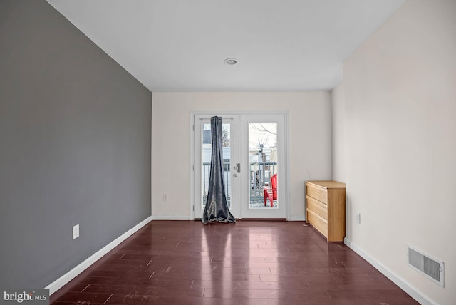 spare room with dark hardwood / wood-style flooring