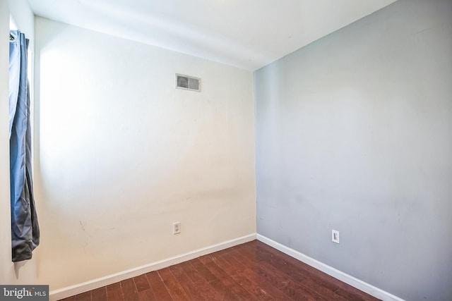 empty room featuring dark hardwood / wood-style flooring