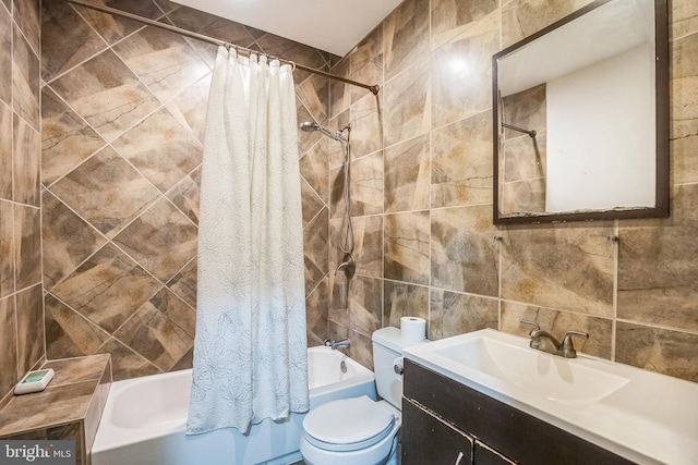 full bathroom featuring vanity, decorative backsplash, toilet, tile walls, and shower / tub combo