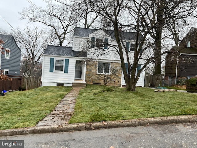 new england style home featuring a front lawn