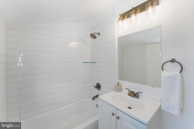 bathroom with vanity, vaulted ceiling, and tiled shower / bath