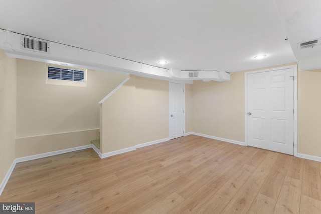 basement with light hardwood / wood-style flooring