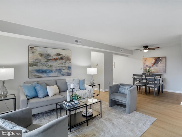 living room featuring light hardwood / wood-style floors and ceiling fan