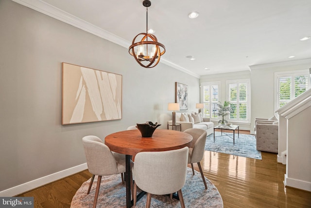 dining room featuring crown molding, dark hardwood / wood-style flooring, and an inviting chandelier