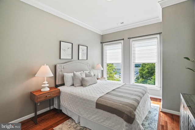 bedroom featuring dark wood-type flooring and ornamental molding