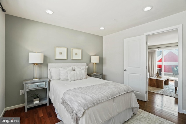 bedroom with dark hardwood / wood-style floors