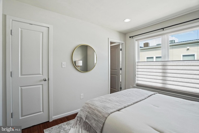 bedroom with dark hardwood / wood-style floors