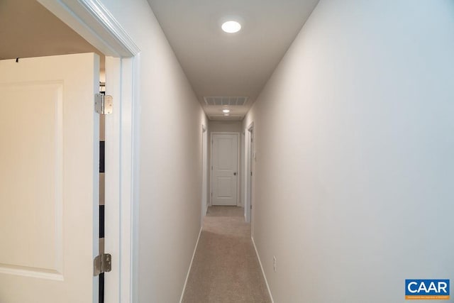 hall featuring light colored carpet