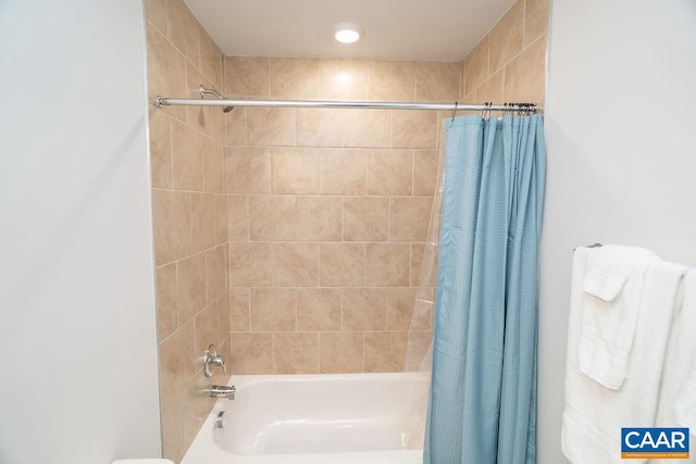 bathroom with shower / bath combo with shower curtain