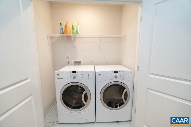 clothes washing area with washer and clothes dryer