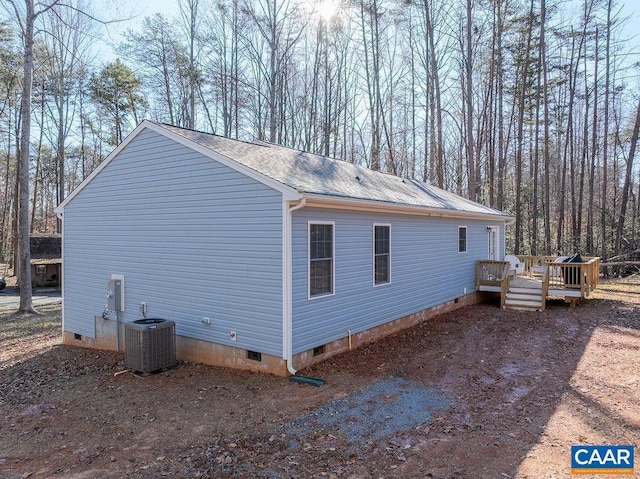 view of property exterior featuring a wooden deck and central AC