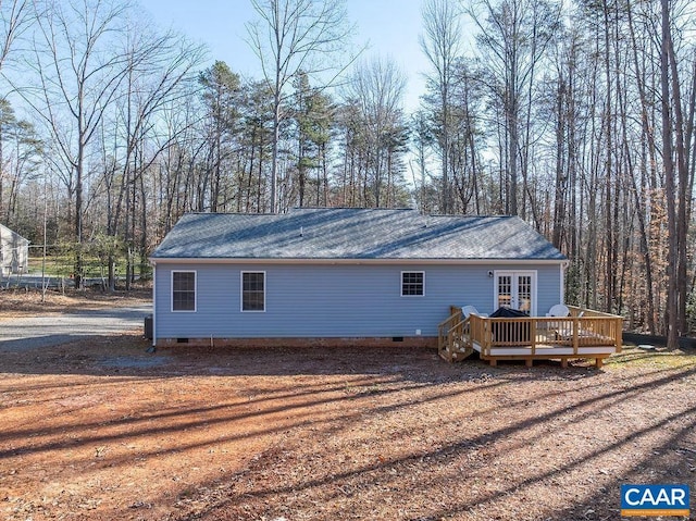 back of house featuring french doors and a wooden deck