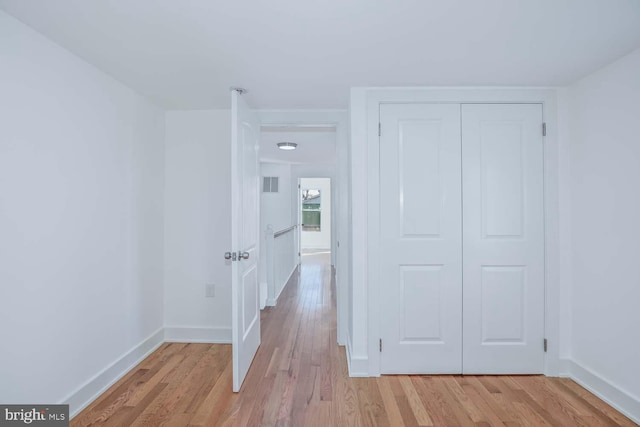 corridor with light wood-type flooring