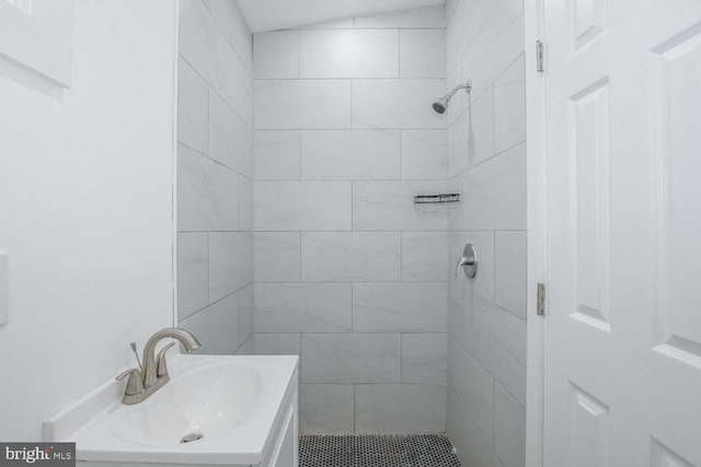 bathroom featuring vanity and tiled shower