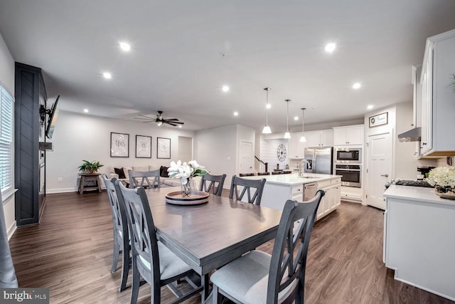 dining room featuring ceiling fan, dark hardwood / wood-style flooring, and sink