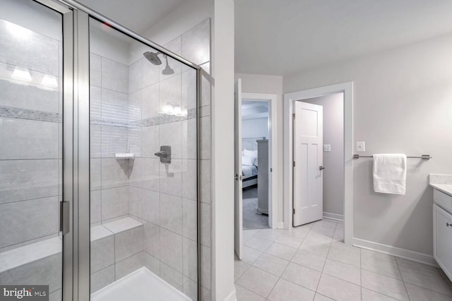 bathroom featuring vanity, tile patterned floors, and a shower with shower door