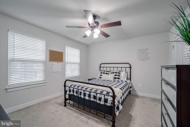 bedroom with ceiling fan and light colored carpet