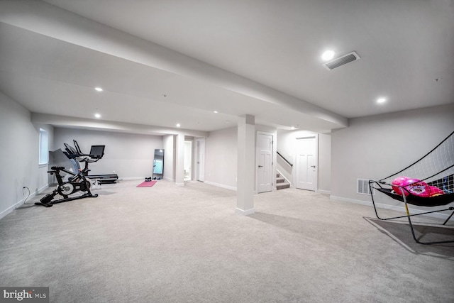 exercise area featuring light colored carpet