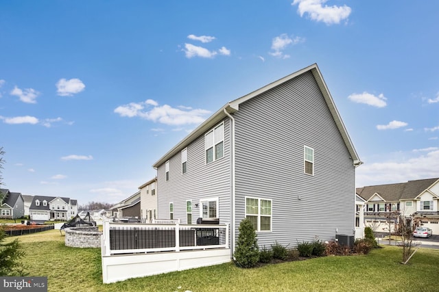 rear view of property with a yard