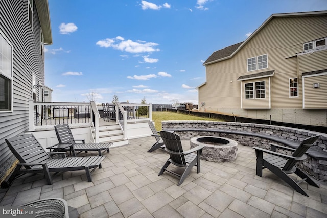 view of patio / terrace with an outdoor fire pit and a wooden deck