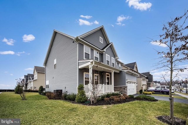 view of side of home featuring a lawn and covered porch