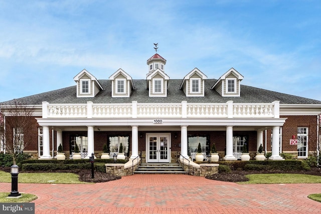 view of front of home with french doors and a porch