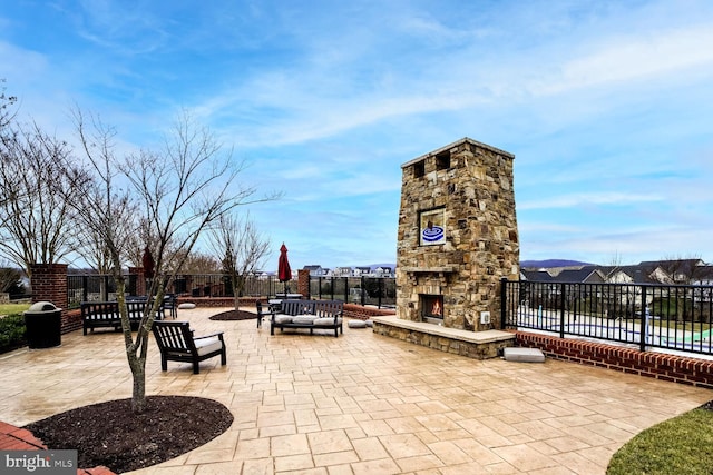 view of patio with an outdoor living space with a fireplace