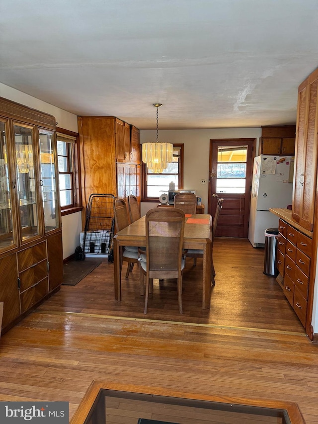 dining area featuring a notable chandelier and dark hardwood / wood-style floors