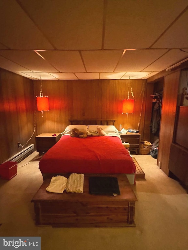 bedroom with carpet flooring and wooden walls