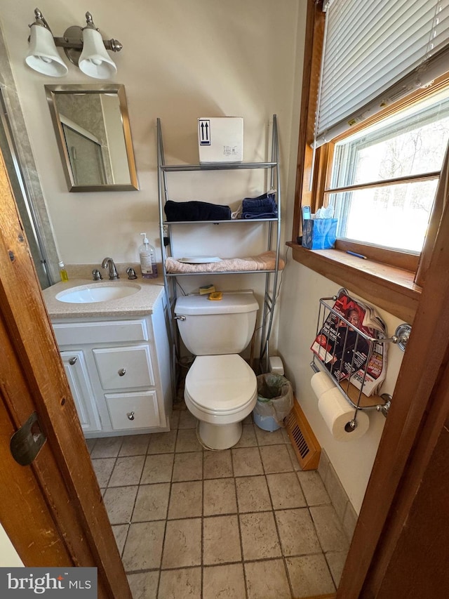 bathroom featuring tile patterned floors, vanity, and toilet