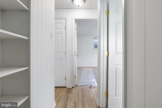 corridor with light hardwood / wood-style flooring