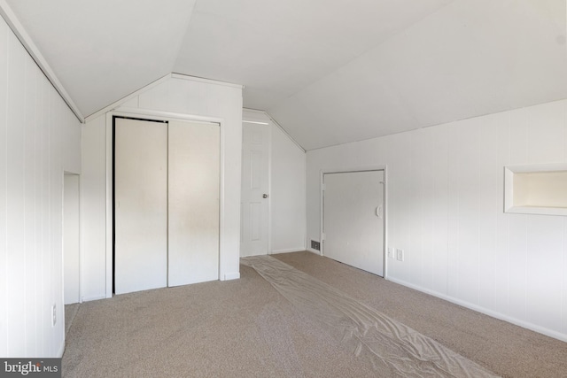 bonus room featuring vaulted ceiling and carpet