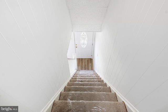 staircase with wooden walls