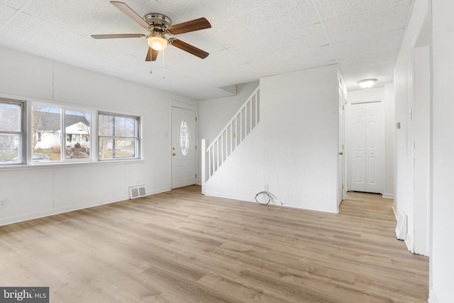 unfurnished living room featuring ceiling fan and light wood-type flooring