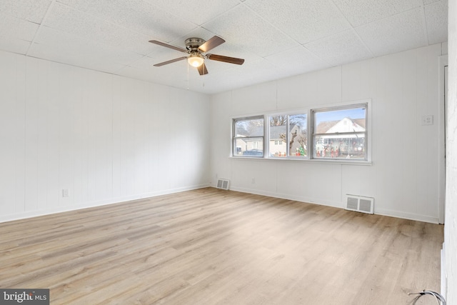 empty room featuring ceiling fan and light hardwood / wood-style floors