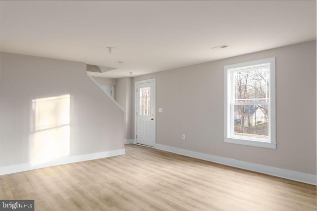 interior space with light hardwood / wood-style flooring and a healthy amount of sunlight