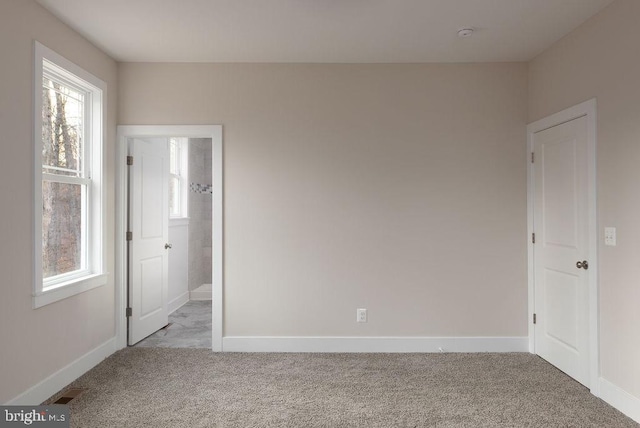 unfurnished room featuring light colored carpet