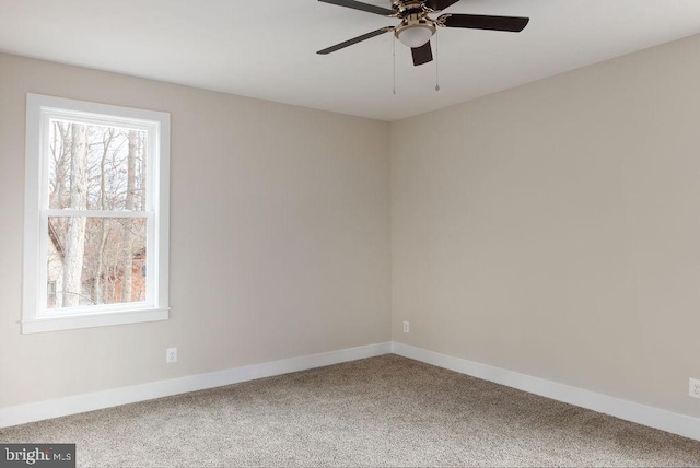 carpeted empty room featuring ceiling fan