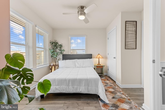 bedroom with hardwood / wood-style flooring and ceiling fan