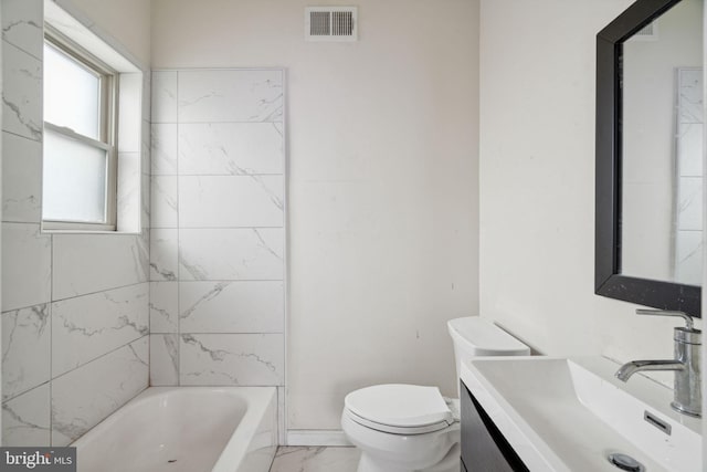 full bathroom with vanity, toilet, and tiled shower / bath combo