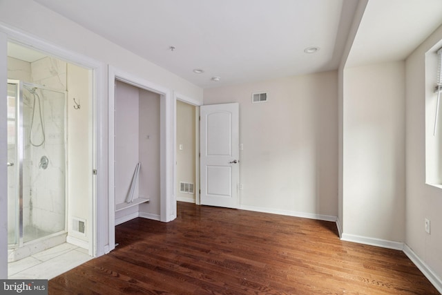 unfurnished bedroom with hardwood / wood-style flooring